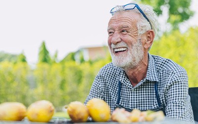 Man smiles at picnic table